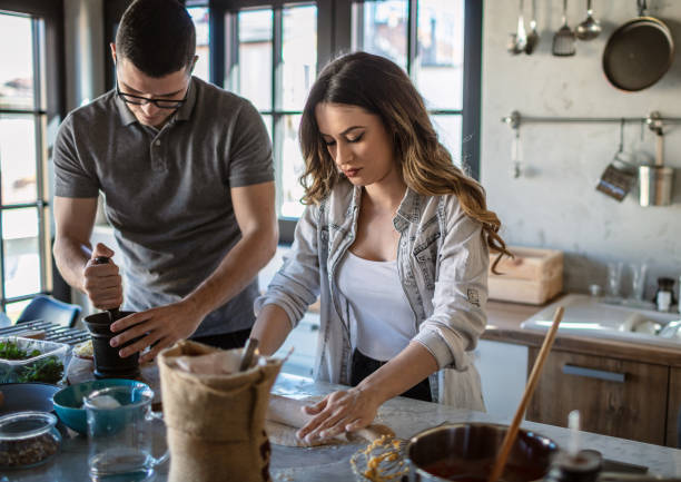 istock Couple preparing pizza at home 1270964787