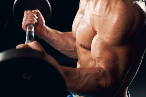 istock Strong man is lifting a barbell with weights 1270964790