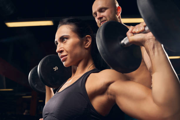 istock Strong female working out at the gym with her partner 1270964795