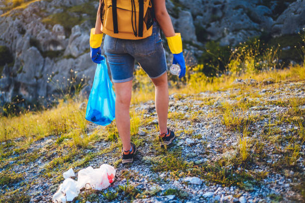istock Woman collects plastic garbage 1270965793