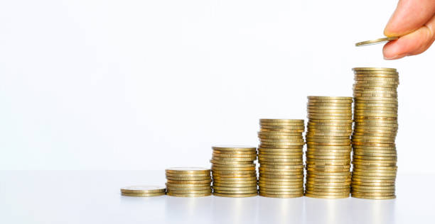 istock business man hand put golden coin stack growth up isolated on white background. money saving, financial growing, business startup, economy budget and investment concept. 1270967145