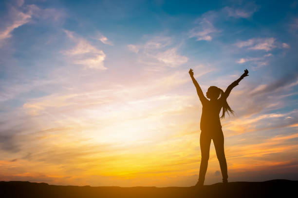 istock Silhouette young woman successful in sunset time. 1270969845