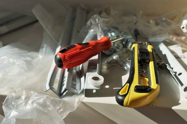 istock Close up view on paper cutter with yellow black plastic handle and snap off utility blade and red screwdriver 1270970267