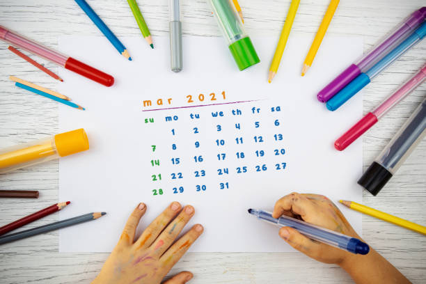 istock Little kindergarten student draws a March 2021 calendar with paints. 1270971468