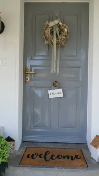 Wooden welcome door at private property in summertime
