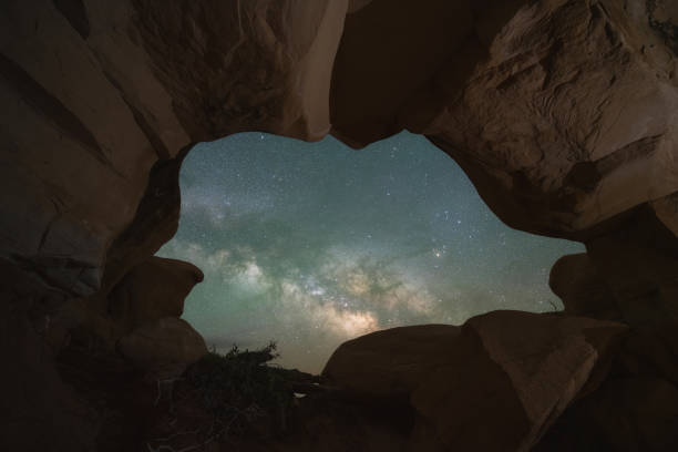 Milky Way Galaxy seen through a hole in the rock at Escalante Utah Hole in the rock in Grand Staircase Escalante Utah and the Milky Way Galaxy escalante stock pictures, royalty-free photos & images