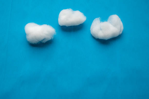 istock Clouds on blue sky reproduction using white cotton wool on blue creped paper background. 1270979820