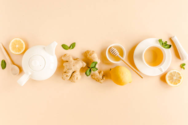 istock Herbal tea with mint, ginger, lemon, honey and other herbs on yellow background. Flat lay, top view 1270980290