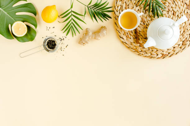 istock Herbal tea with mint, ginger, lemon, honey and other herbs on yellow background. Flat lay, top view 1270980596