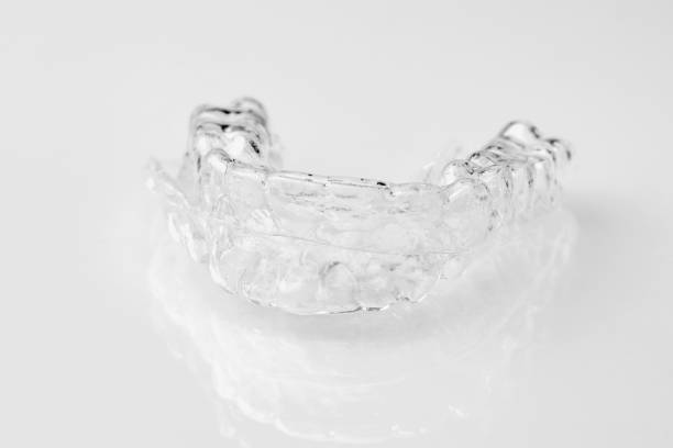 istock Two Invisible dental teeth aligners on the white background. Orthodontic temporary removable braces for fixing teeth after alignment. Therapy after brackets. 1270981312