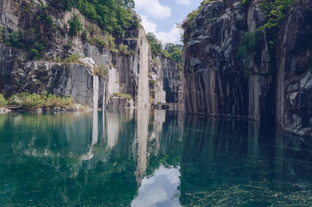 beautiful turquoise lake between rugged cliffs on cloudy spring day