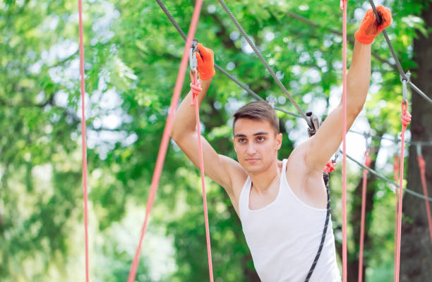 istock Man spend their leisure time in a ropes course. Man engaged in rope park. 1270984479