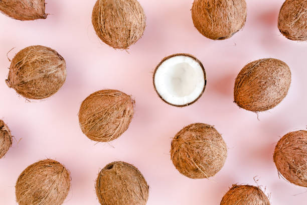 istock Pattern, texture with coconuts and tropical palm leaves on pink background. Tropical abstract background. Flat lay, top view 1270985233