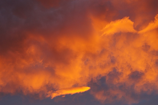 Orange and red coloured clouds during dusk