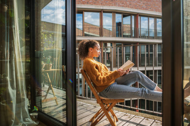 Young woman reading a book at home