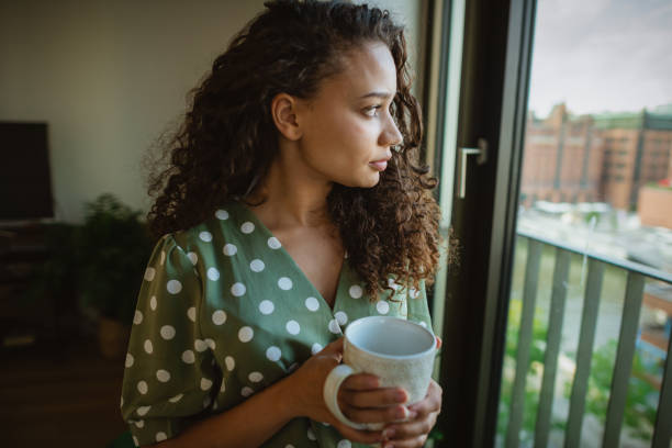 istock Young woman , drinks coffee and relaxing in her apartment 1270989408
