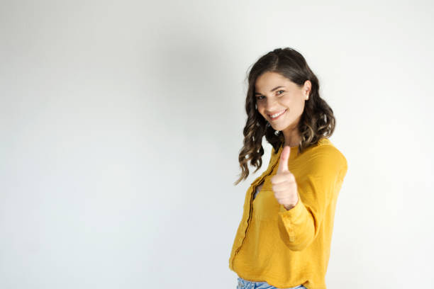 attractive female showing thumbs up - thumbs up business people isolated imagens e fotografias de stock