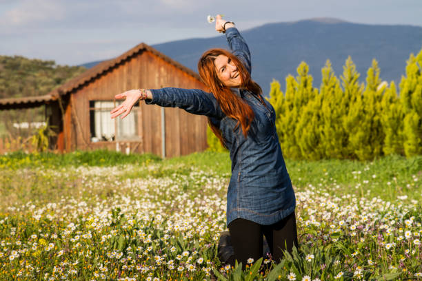 Young girl with brown hair practising acrobatics in a field.