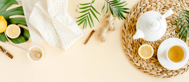 istock Herbal tea with mint, ginger, lemon, honey and other herbs on yellow background. Flat lay, top view 1270989595