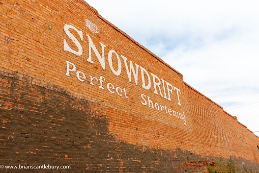 Winslow Arizona USA - September 22 2015; Traditional American cooking product brand sign in white lettering on orange brick wall.