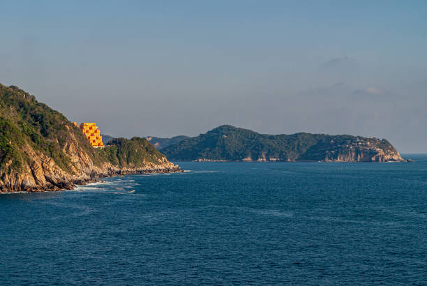 This is a horizontal, color photograph shot in Quimixto near travel destination, Puerto Vallarta, Mexico of the scenic rocky coastline along the Pacific Ocean.