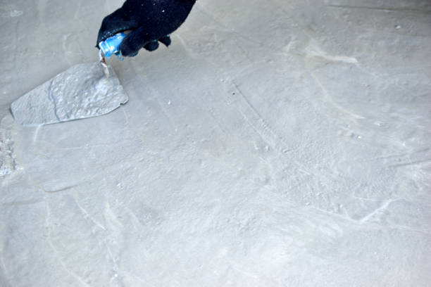 istock Working on concrete with a trowel leveling the surface 1270992388