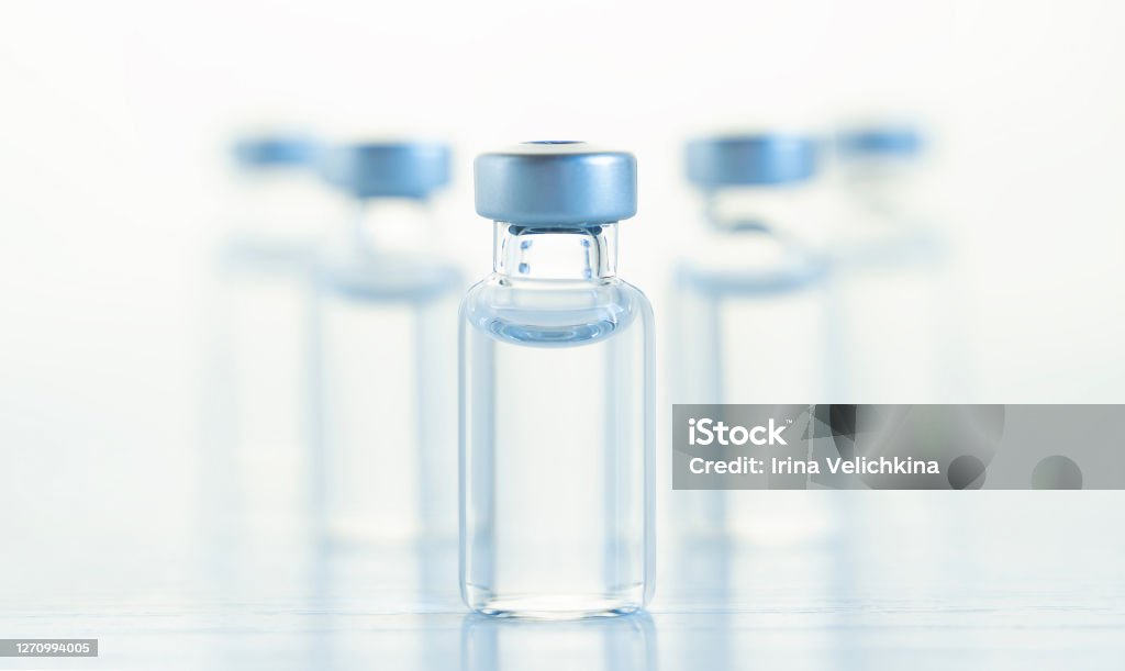 Many transparent vials with vaccine for covid-19 coronavirus, flu, infectious diseases. Injection after clinical trials for vaccination of human, child, adult, senior. Medicine, drug concept Many transparent vials with vaccine for covid-19 coronavirus, flu, infectious diseases. Injection after clinical trials for vaccination of human, child, adult, senior. Medicine, drug concept. Vaccination Stock Photo