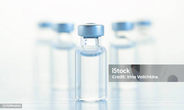 Many Transparent Vials With Vaccine For Covid19 Coronavirus Flu Infectious Diseases Injection After Clinical Trials For Vaccination Of Human Child Adult Senior Medicine Drug Concept Stock Photo - Download Image Now