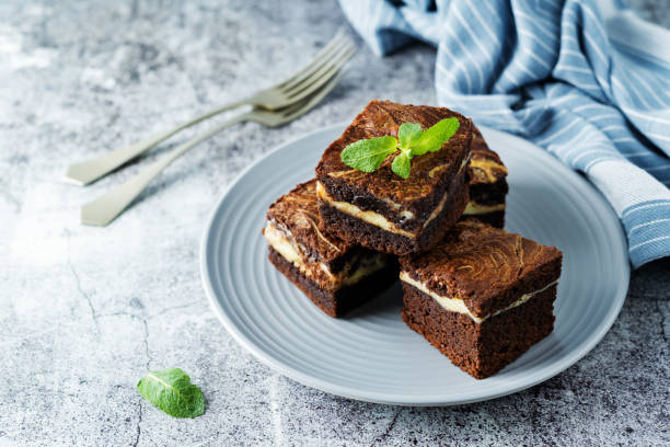 istock Cream cheese chocolate brownie with mint leaves 1270996430