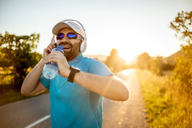 istock Athlete doing exercises on the road in nature - An athlete who runs outdoors for exercise and fitness - Athletic Man Doing Running 1270999409