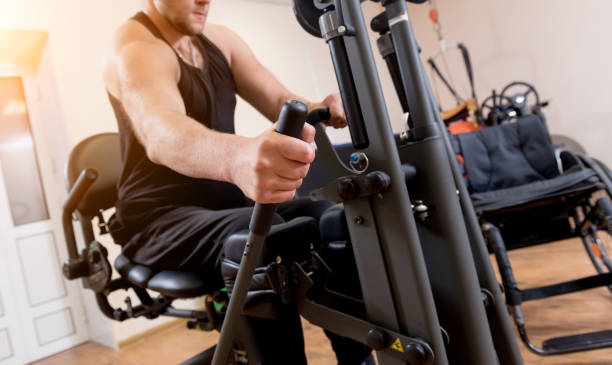 istock Disabled man training in the gym. Rehabilitation center 1270999514