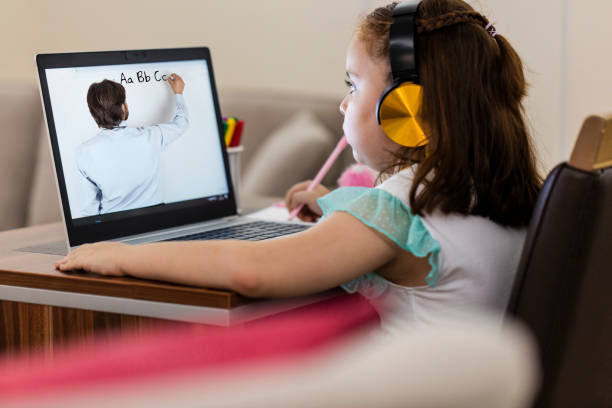 istock Little girl attending to online school class 1271000104