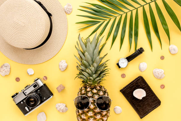 istock Pattern traveler with pineapple in sunglasses, palm leaf with camera. Flat lay, top view. Summer background 1271000179