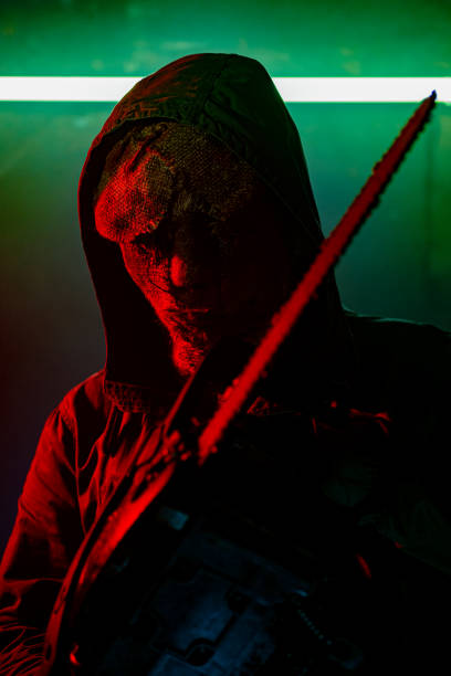 istock Mad horror masked man in darkness 1271001718