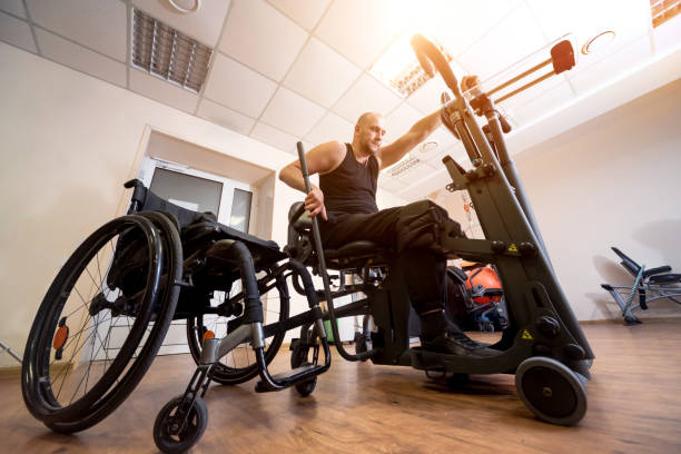 istock Disabled man training in the gym. Rehabilitation center 1271001822