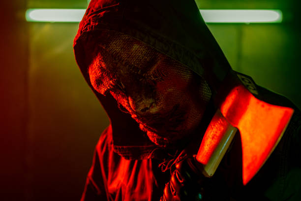istock Scarry man wearing a mask holding an axe. 1271001851