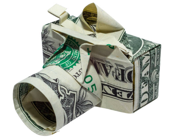 istock Money Origami CAMERA Left Side Folded with Real One Dollar Bill Isolated on White Background 1271002986
