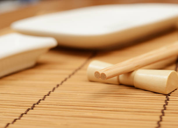 istock japanese chopsticks on stand, bamboo mat and sushi dishes 1271003156