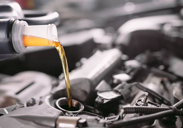 istock Motor oil pouring to car engine. A service station. 1271007733