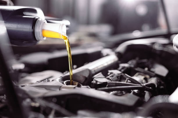 istock Motor oil pouring to car engine. A service station. 1271007759