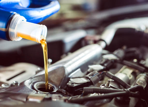 istock Motor oil pouring to car engine. A service station. 1271007786