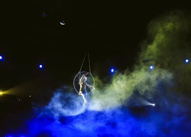istock Aerial acrobat in the ring. A young girl performs the acrobatic elements in the air ring 1271007952
