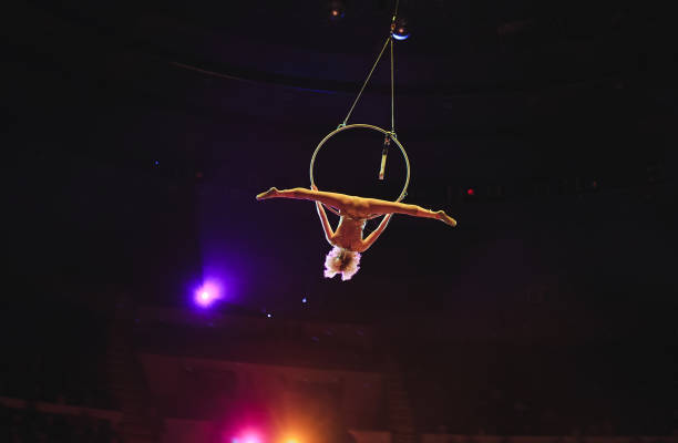 istock Aerial acrobat in the ring. A young girl performs the acrobatic elements in the air ring 1271007981