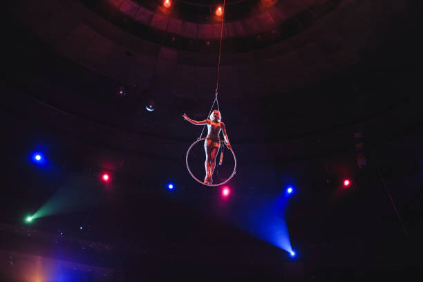 istock Aerial acrobat in the ring. A young girl performs the acrobatic elements in the air ring 1271007994