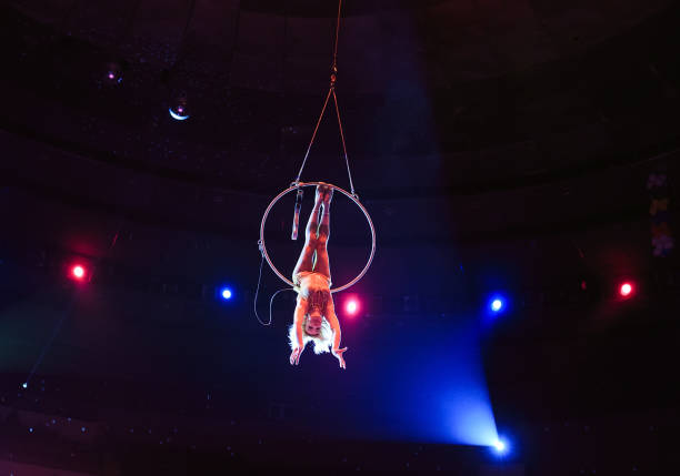 istock Aerial acrobat in the ring. A young girl performs the acrobatic elements in the air ring 1271008021