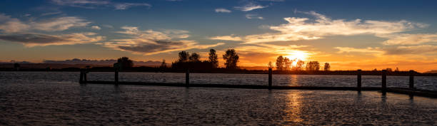 Panorama of sunset on water Jetty Island Port Gardner Everett Washington Panorama of sunset on water Jetty Island Port Gardner Everett Washington everett washington state photos stock pictures, royalty-free photos & images
