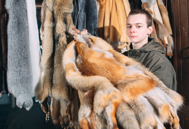 istock A young man hangs up the fur after treatment. 1271008948