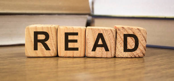 istock Read words on wooden blocks with Books on blurred backround 1271009617