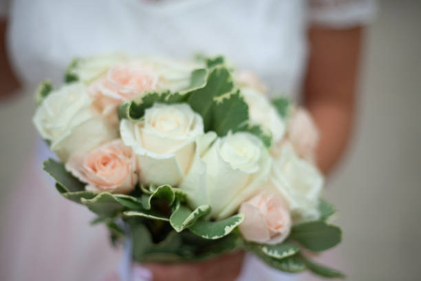 Attractive man is holding red roses to give away.