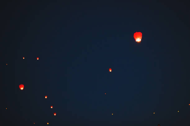 istock Flying lantern in the dark sky at night 1271012564